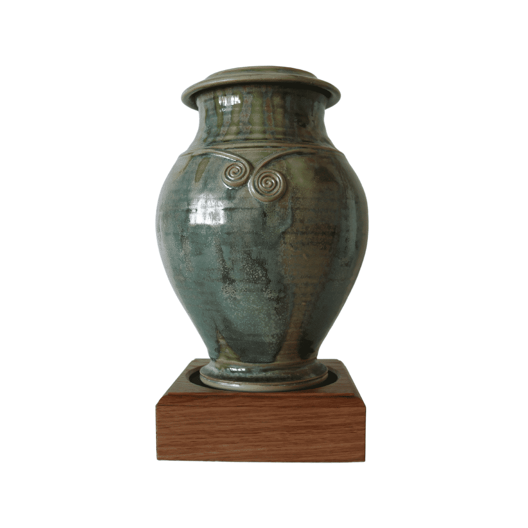 Fern colored Urn in torc design on stand of wood