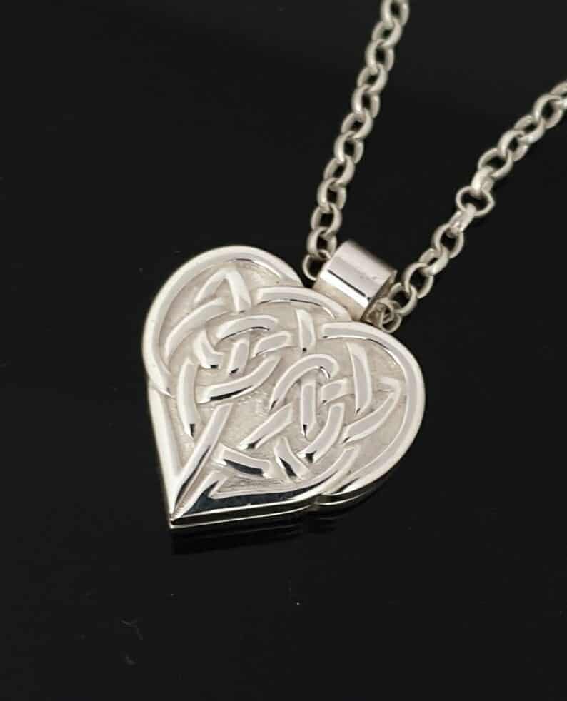 Celtic knot on heart shaped pendant cremation keepsake pendant from ireland on black background