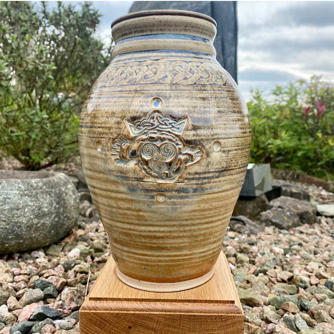 Claddagh Urn - Cremation Urn with barley yellow glaze by irish urns on an oak plinth